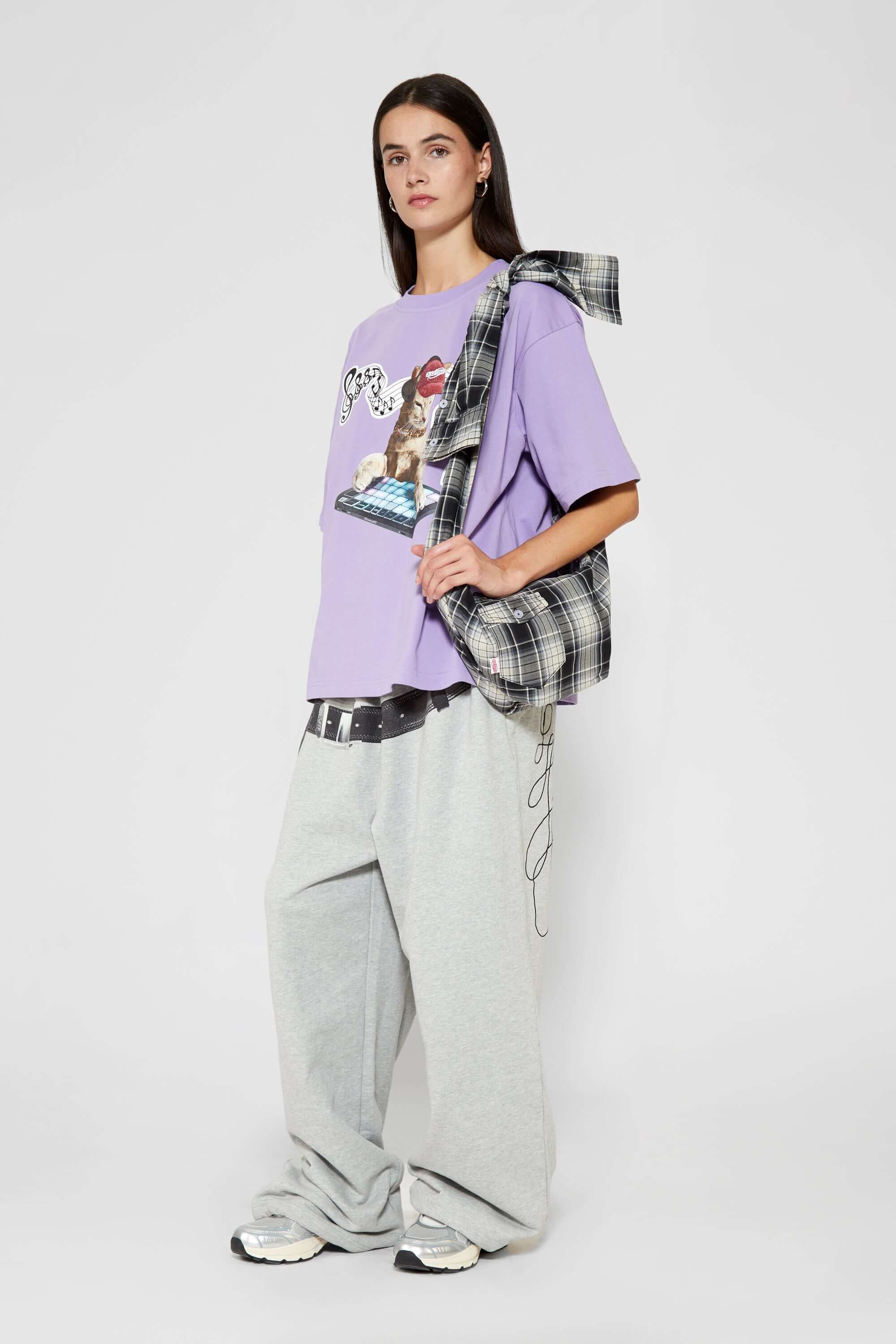 Black and white checked croissant-shaped mini bag with shirt texture and adjustable sleeve handles for shoulder or crossbody wear