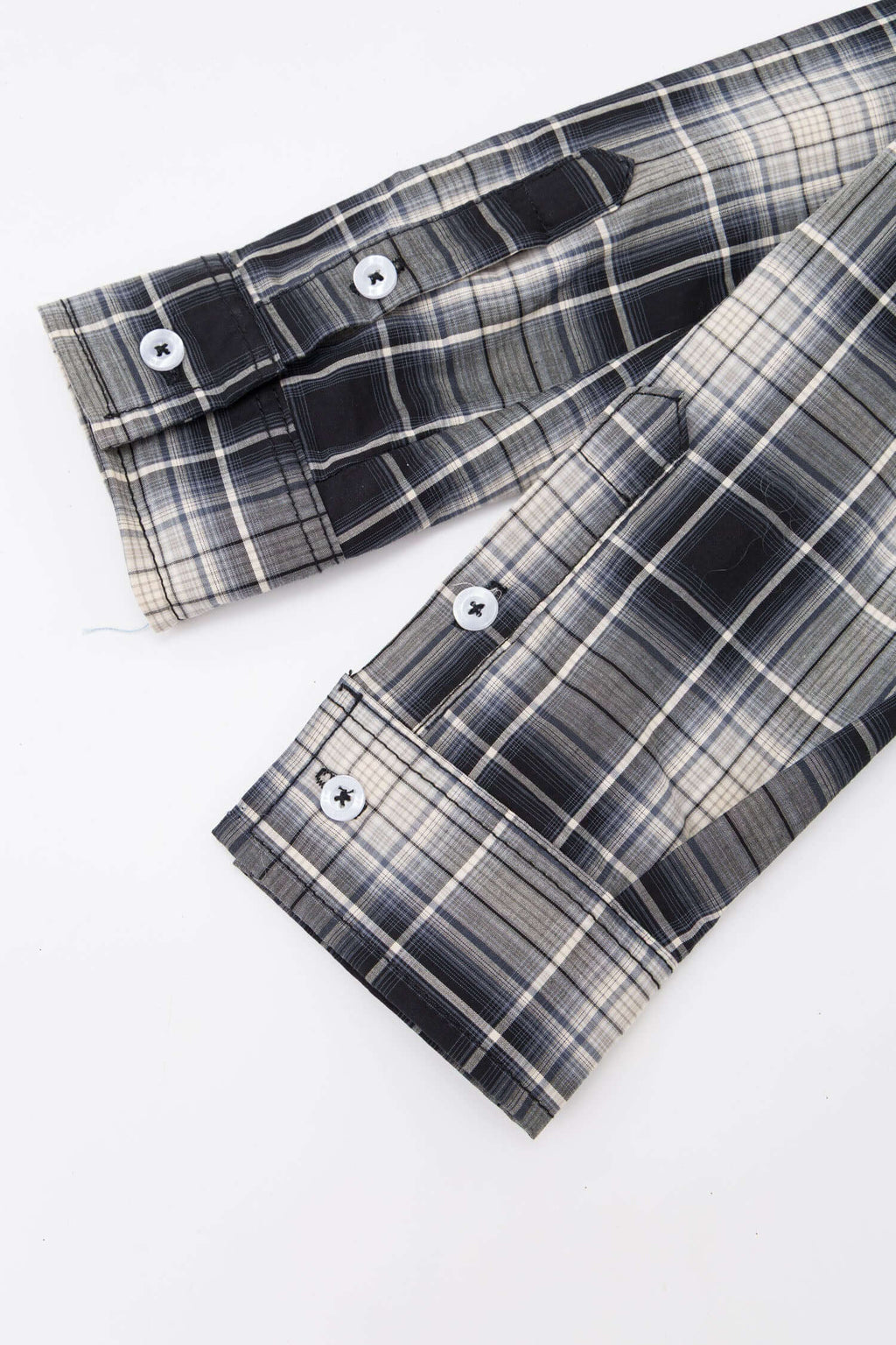 Black and white checked croissant-shaped mini bag with shirt texture and adjustable sleeve handles for shoulder or crossbody wear