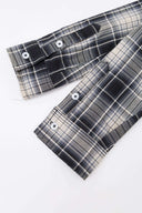 Black and white checked croissant-shaped mini bag with shirt texture and adjustable sleeve handles for shoulder or crossbody wear