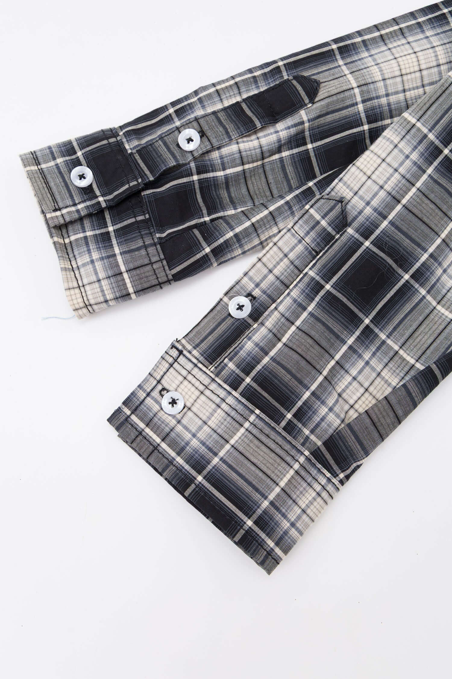Black and white checked croissant-shaped mini bag with shirt texture and adjustable sleeve handles for shoulder or crossbody wear