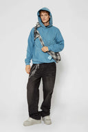 Black and white checked croissant-shaped mini bag with shirt texture and adjustable sleeve handles for shoulder or crossbody wear