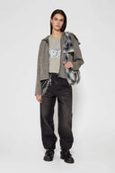 Black and white checked croissant-shaped mini bag with shirt texture and adjustable sleeve handles for shoulder or crossbody wear