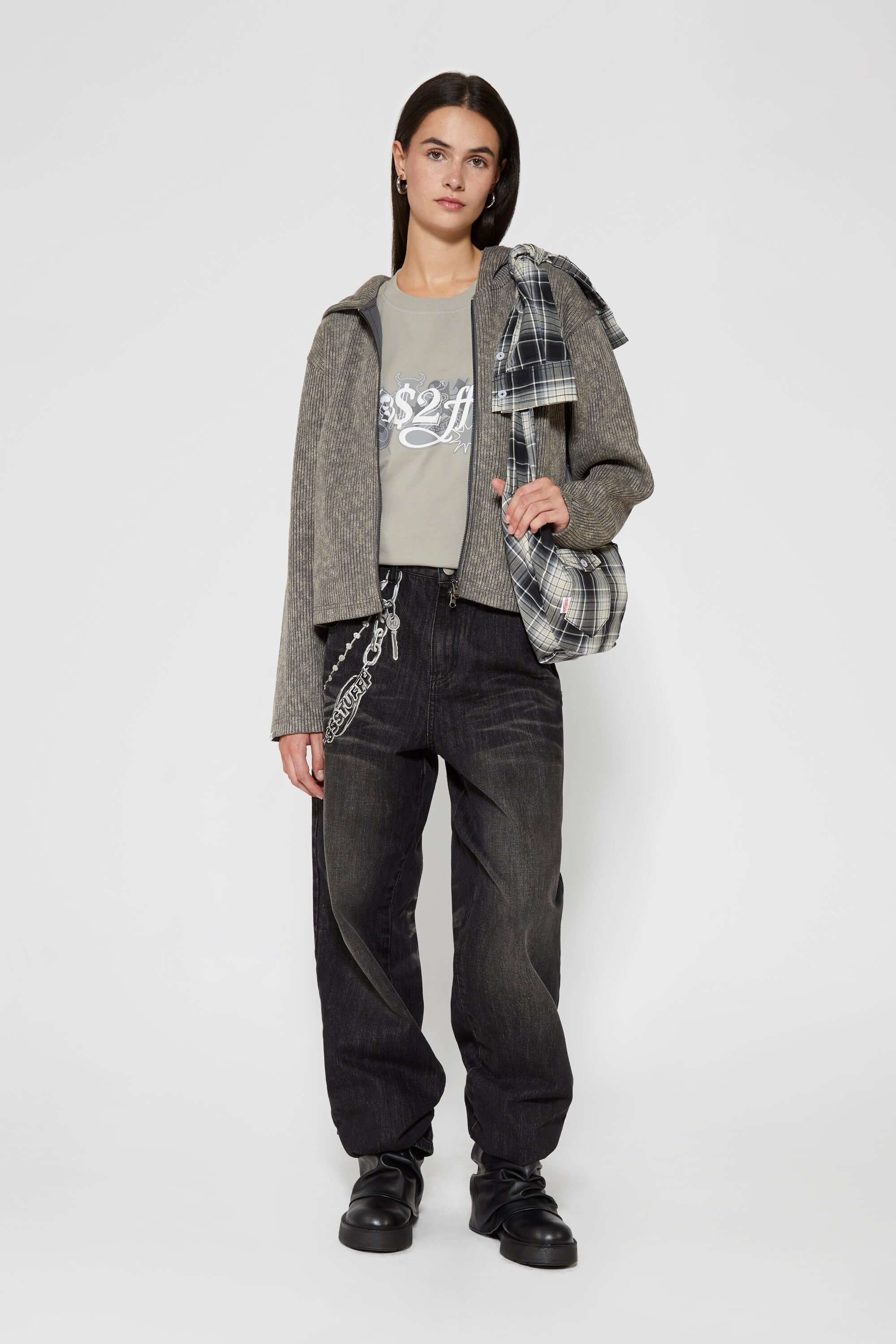 Black and white checked croissant-shaped mini bag with shirt texture and adjustable sleeve handles for shoulder or crossbody wear
