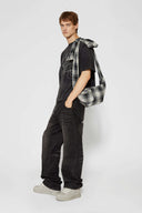 Black and white checked croissant-shaped mini bag with shirt texture and adjustable sleeve handles for shoulder or crossbody wear