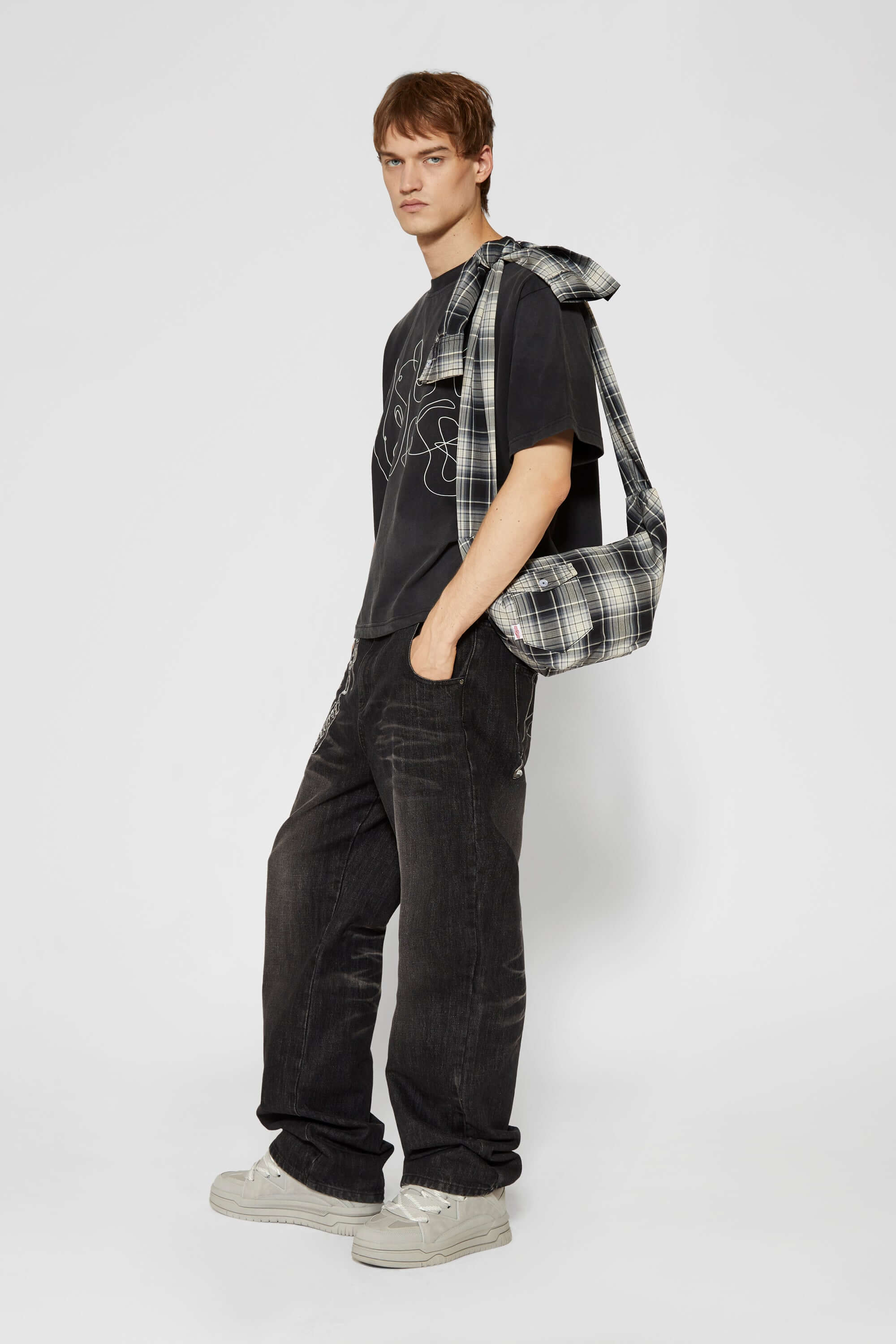 Black and white checked croissant-shaped mini bag with shirt texture and adjustable sleeve handles for shoulder or crossbody wear