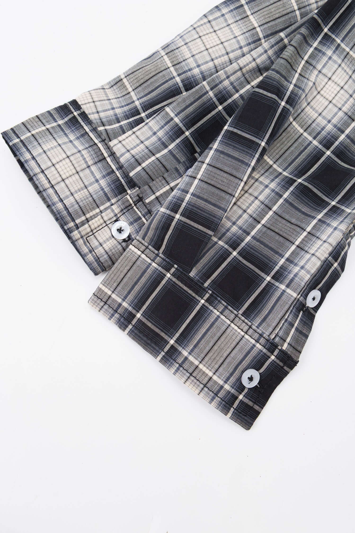 Black and white checked croissant-shaped bag with shirt texture and adjustable sleeve handles for shoulder or crossbody wear