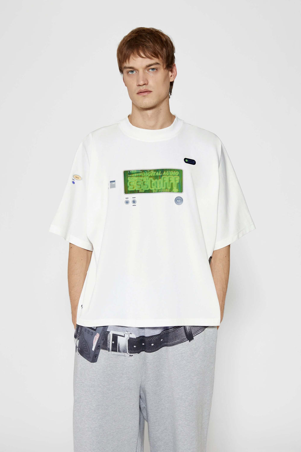 White oversized t-shirt with cyberpunk digital audio stereo interface print, TPU buttons, and holographic SSSTUFFF motif