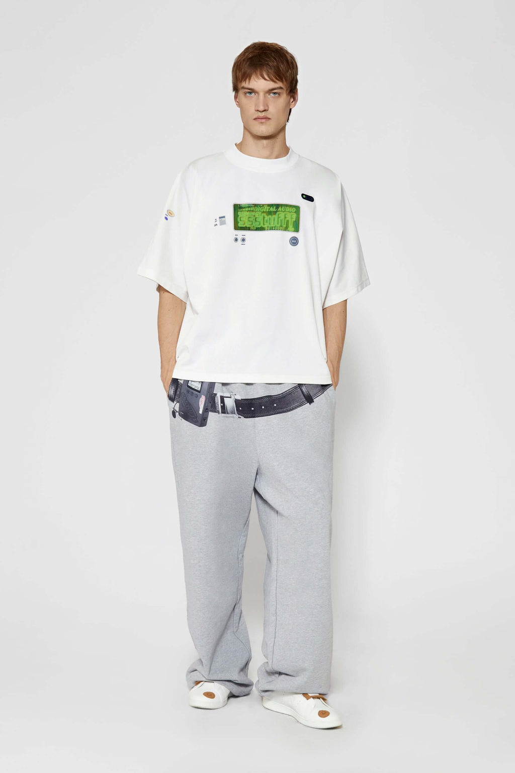White oversized t-shirt with cyberpunk digital audio stereo interface print, TPU buttons, and holographic SSSTUFFF motif