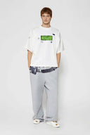 White oversized t-shirt with cyberpunk digital audio stereo interface print, TPU buttons, and holographic SSSTUFFF motif