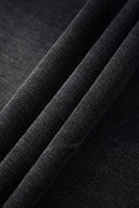 Black wash denim jeans with embroidered keychain, carabiner, and earphone charm details, and pin embroidery on ankle