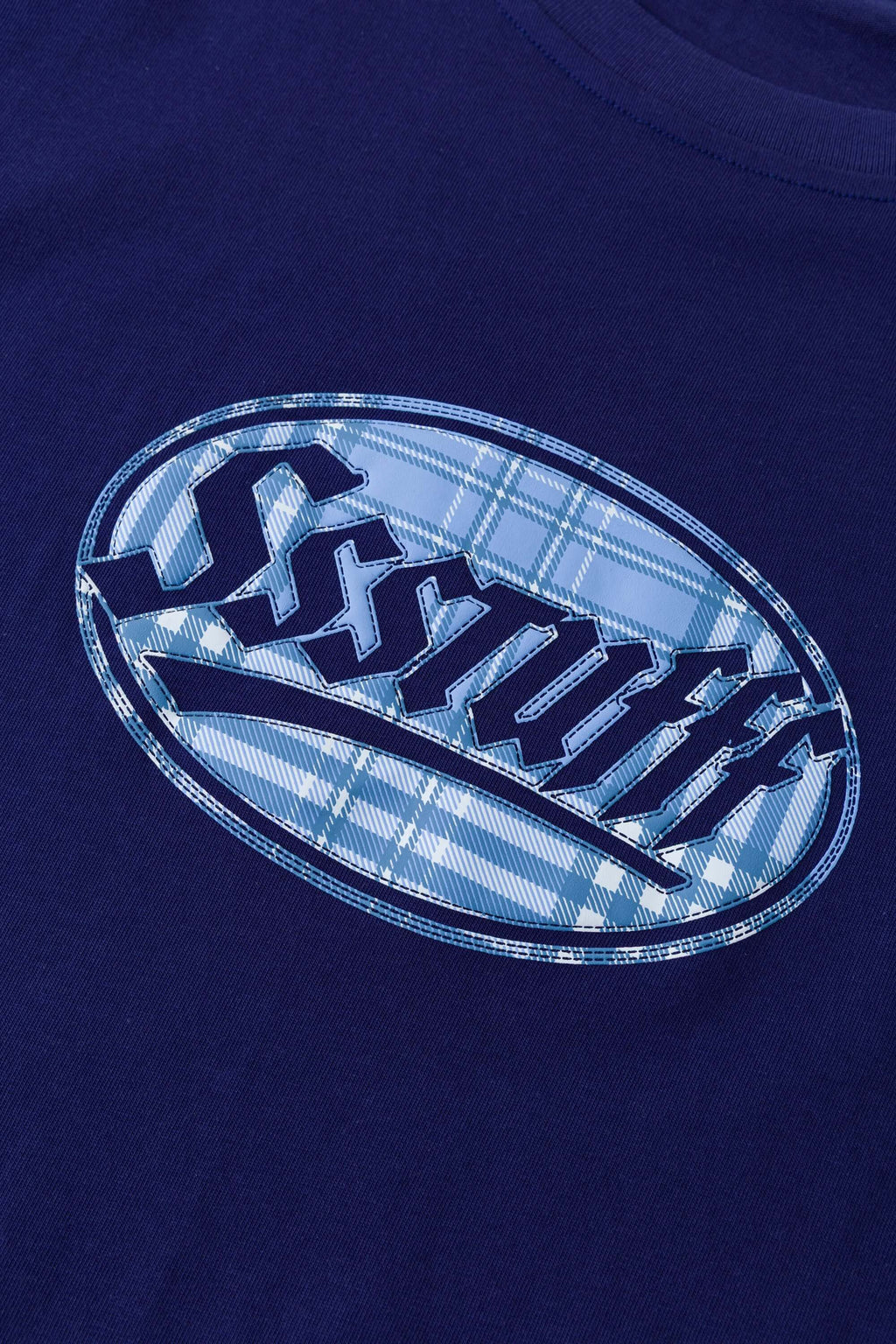 Navy t-shirt with check patchwork and puff-printed details that mimic stitching