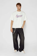 White t-shirt with check patchwork and puff-printed details that mimic stitching