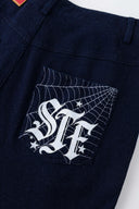 Denim-effect sweatpants with gothic STF embroidery, custom SSSTUFFF metal button, and leather patch with functional compass