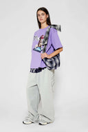 Purple t-shirt with embroidered SSSTUFFF logo and silicone-printed musical notes