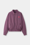 Reversible jacket with burgundy and grey micro-check pattern on one side and purple fleece on reverse