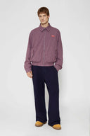 Reversible jacket with burgundy and grey micro-check pattern on one side and purple fleece on reverse