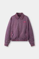Reversible jacket with burgundy and grey micro-check pattern on one side and purple fleece on reverse