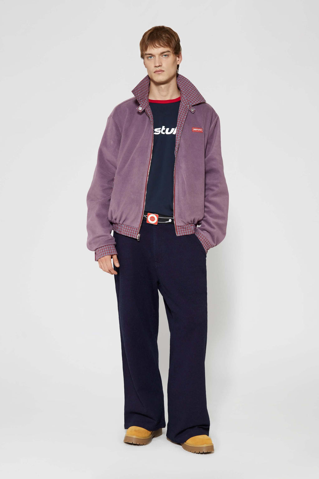 Reversible jacket with burgundy and grey micro-check pattern on one side and purple fleece on reverse