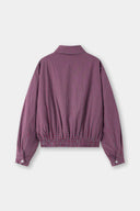 Reversible jacket with burgundy and grey micro-check pattern on one side and purple fleece on reverse