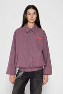 Reversible jacket with burgundy and grey micro-check pattern on one side and purple fleece on reverse