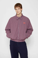 Reversible jacket with burgundy and grey micro-check pattern on one side and purple fleece on reverse
