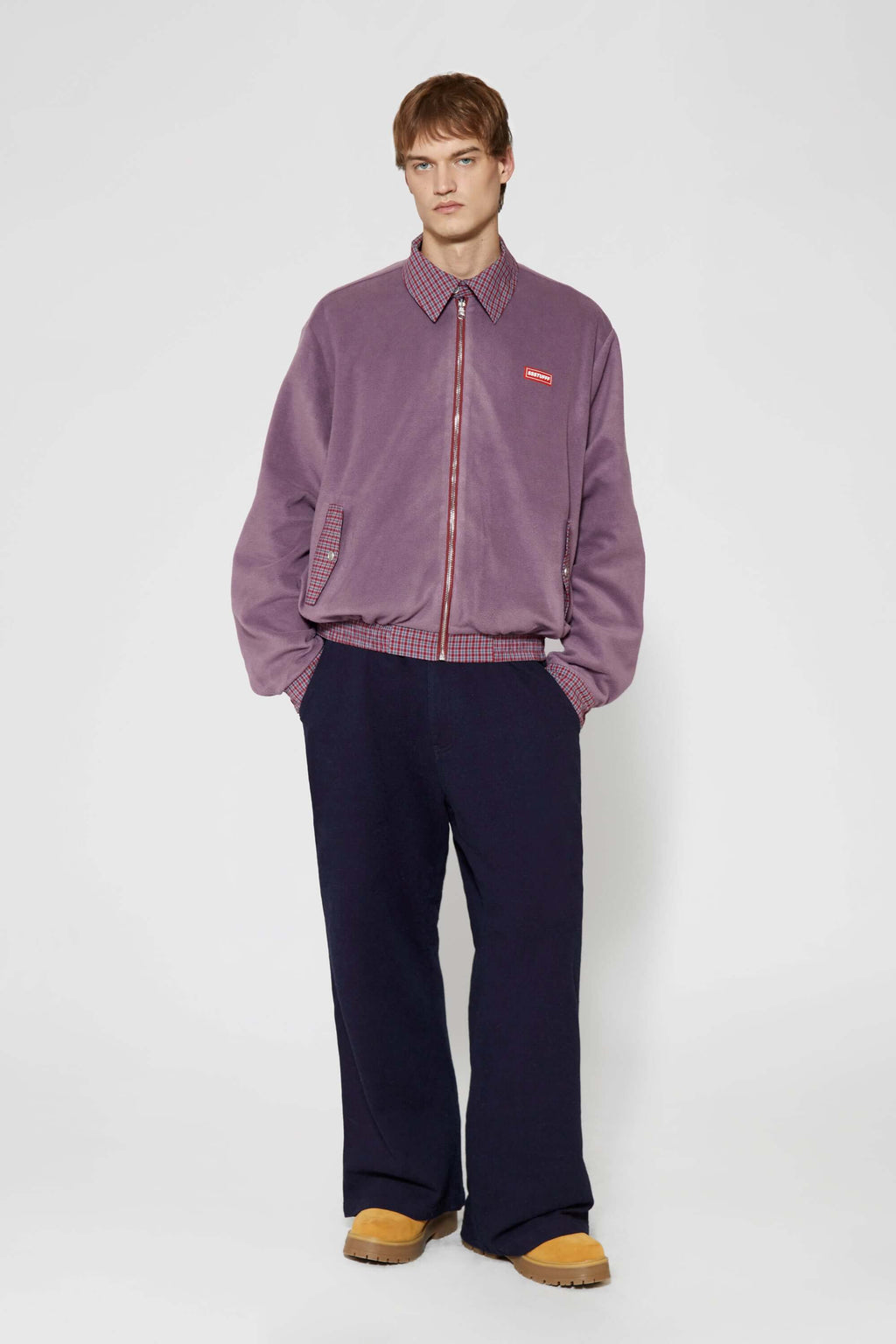 Reversible jacket with burgundy and grey micro-check pattern on one side and purple fleece on reverse
