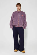 Reversible jacket with burgundy and grey micro-check pattern on one side and purple fleece on reverse