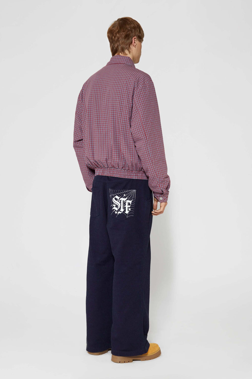 Reversible jacket with burgundy and grey micro-check pattern on one side and purple fleece on reverse