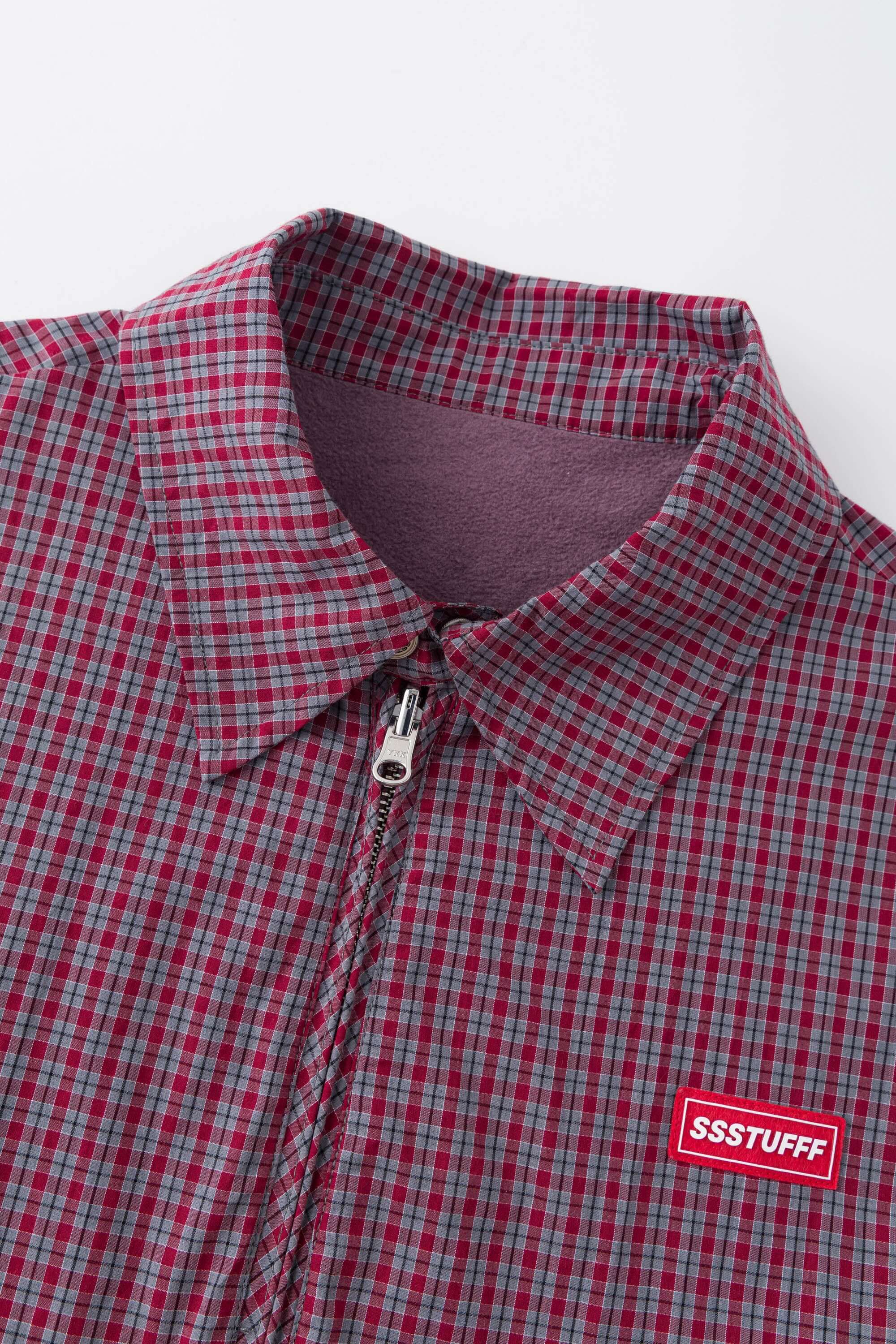 Reversible jacket with burgundy and grey micro-check pattern on one side and purple fleece on reverse