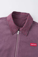 Reversible jacket with burgundy and grey micro-check pattern on one side and purple fleece on reverse