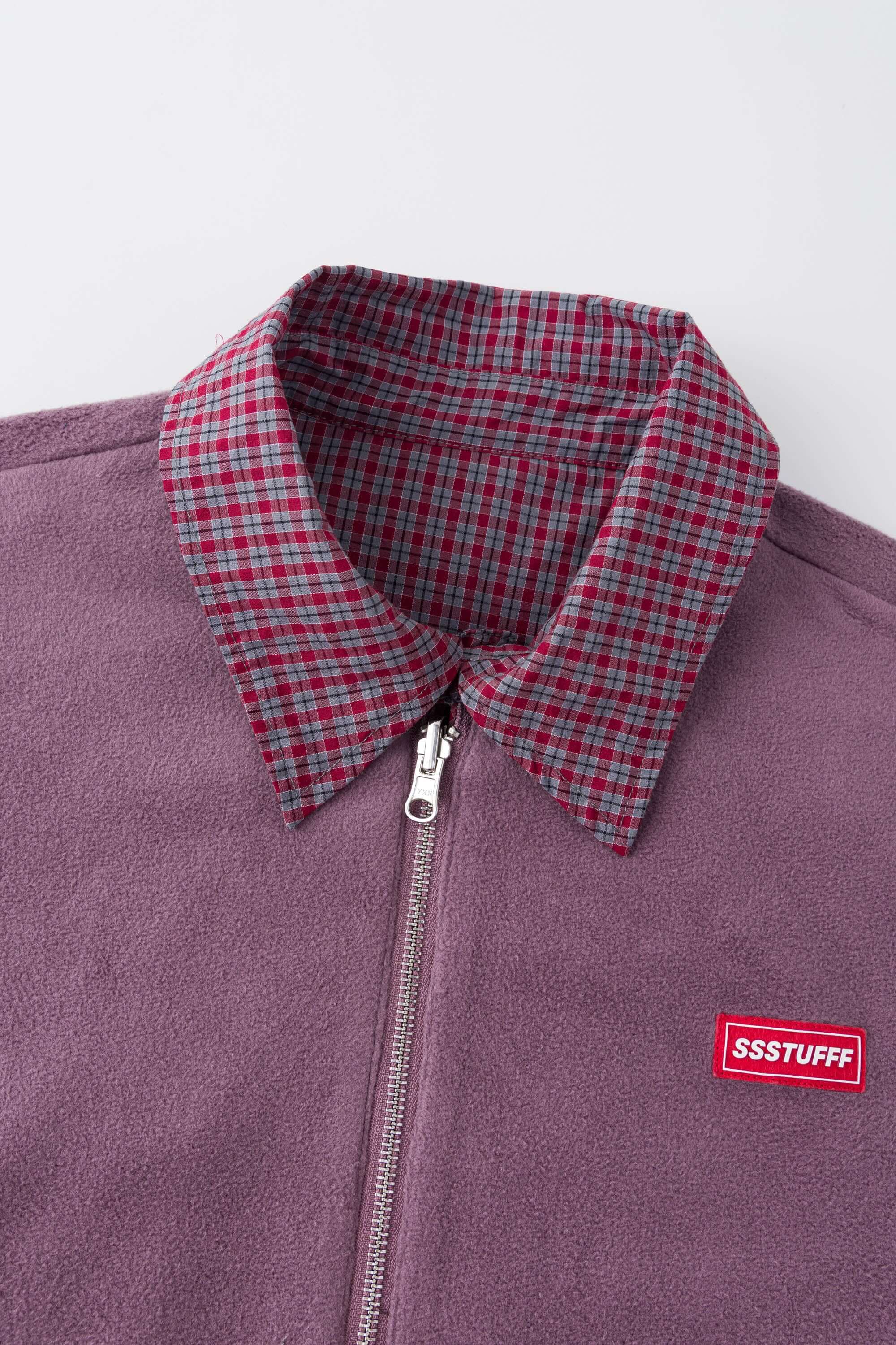 Reversible jacket with burgundy and grey micro-check pattern on one side and purple fleece on reverse