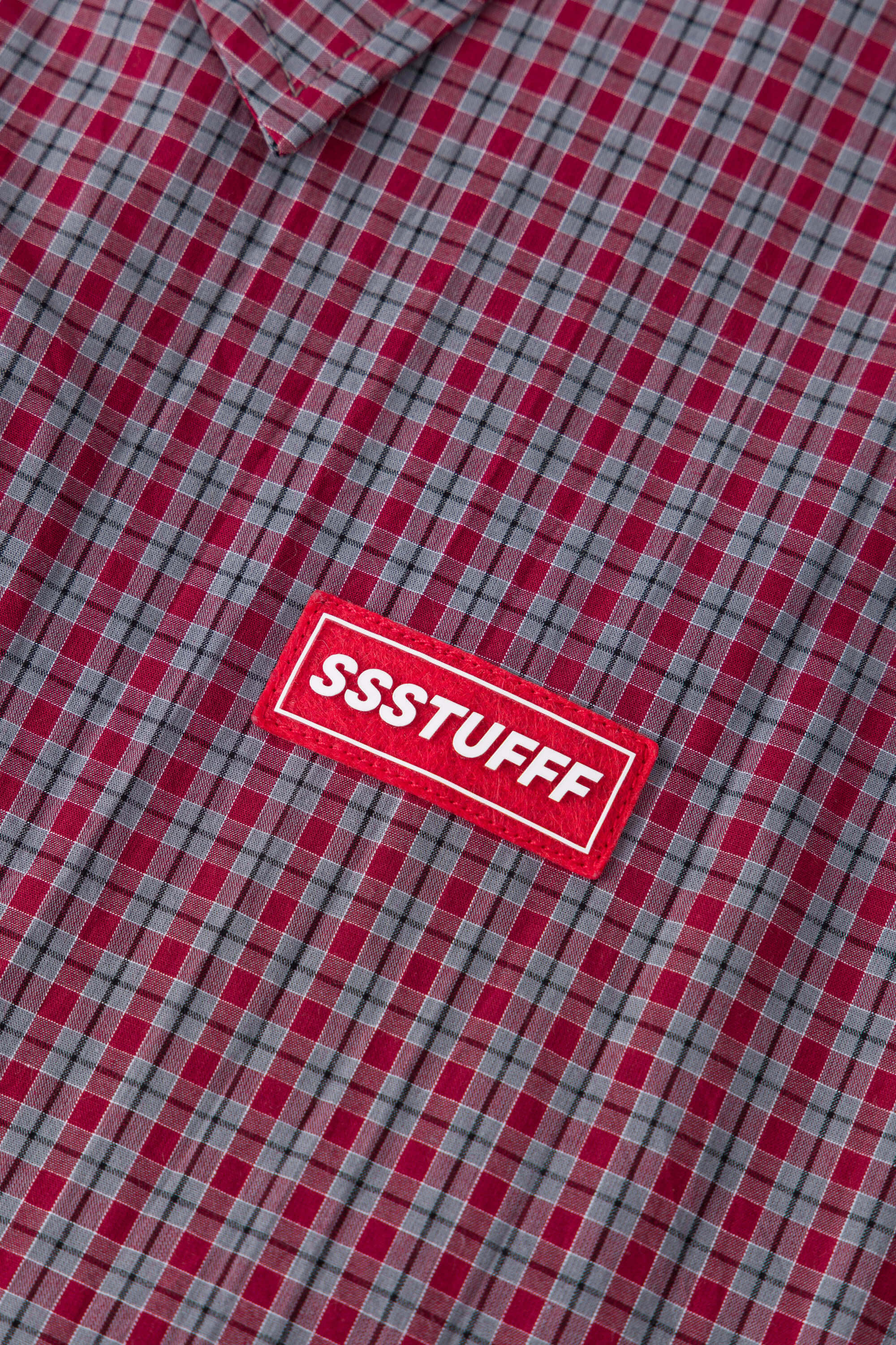 Reversible jacket with burgundy and grey micro-check pattern on one side and purple fleece on reverse