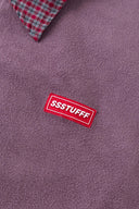 Reversible jacket with burgundy and grey micro-check pattern on one side and purple fleece on reverse