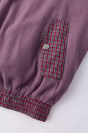 Reversible jacket with burgundy and grey micro-check pattern on one side and purple fleece on reverse
