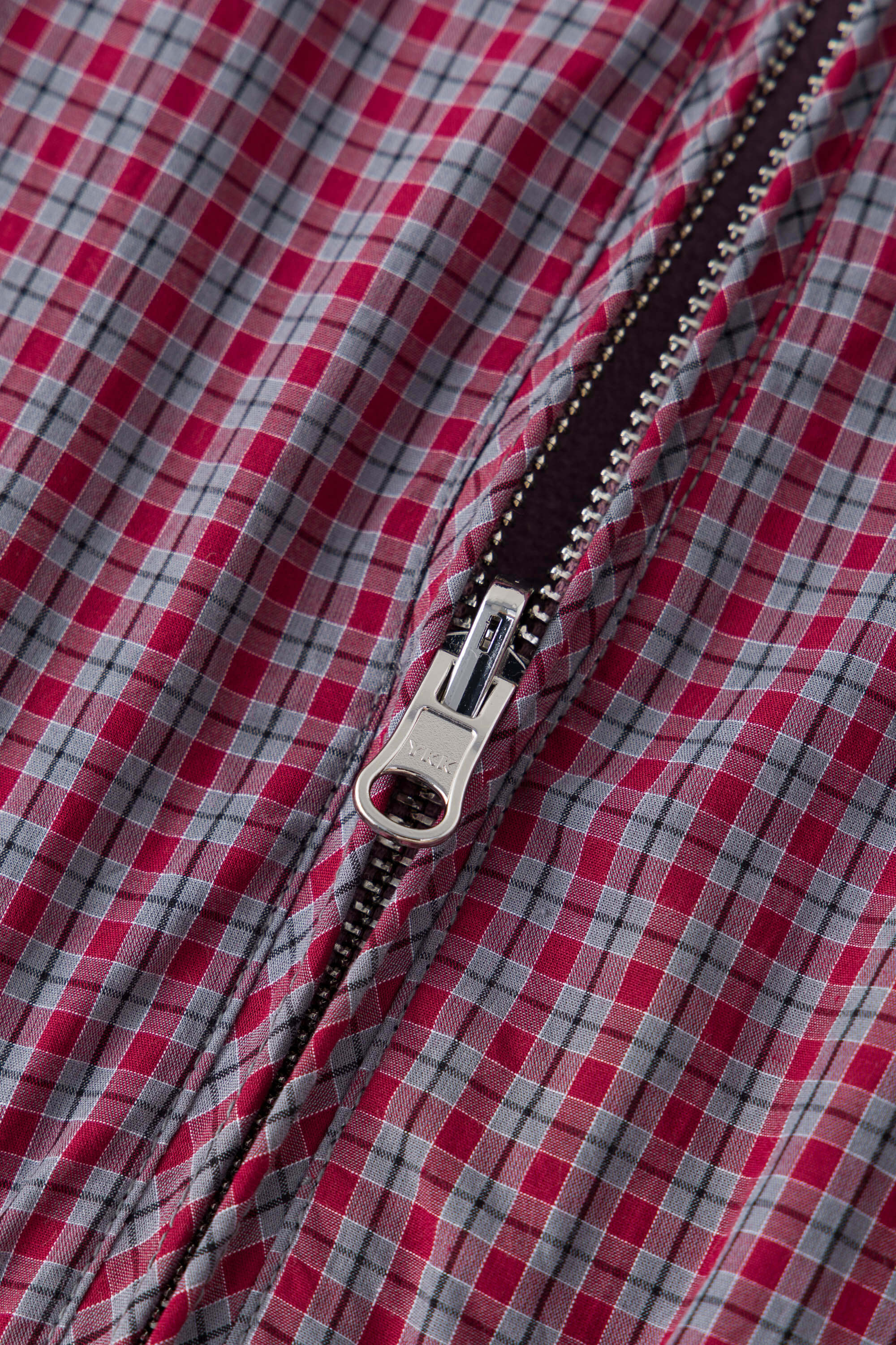 Reversible jacket with burgundy and grey micro-check pattern on one side and purple fleece on reverse