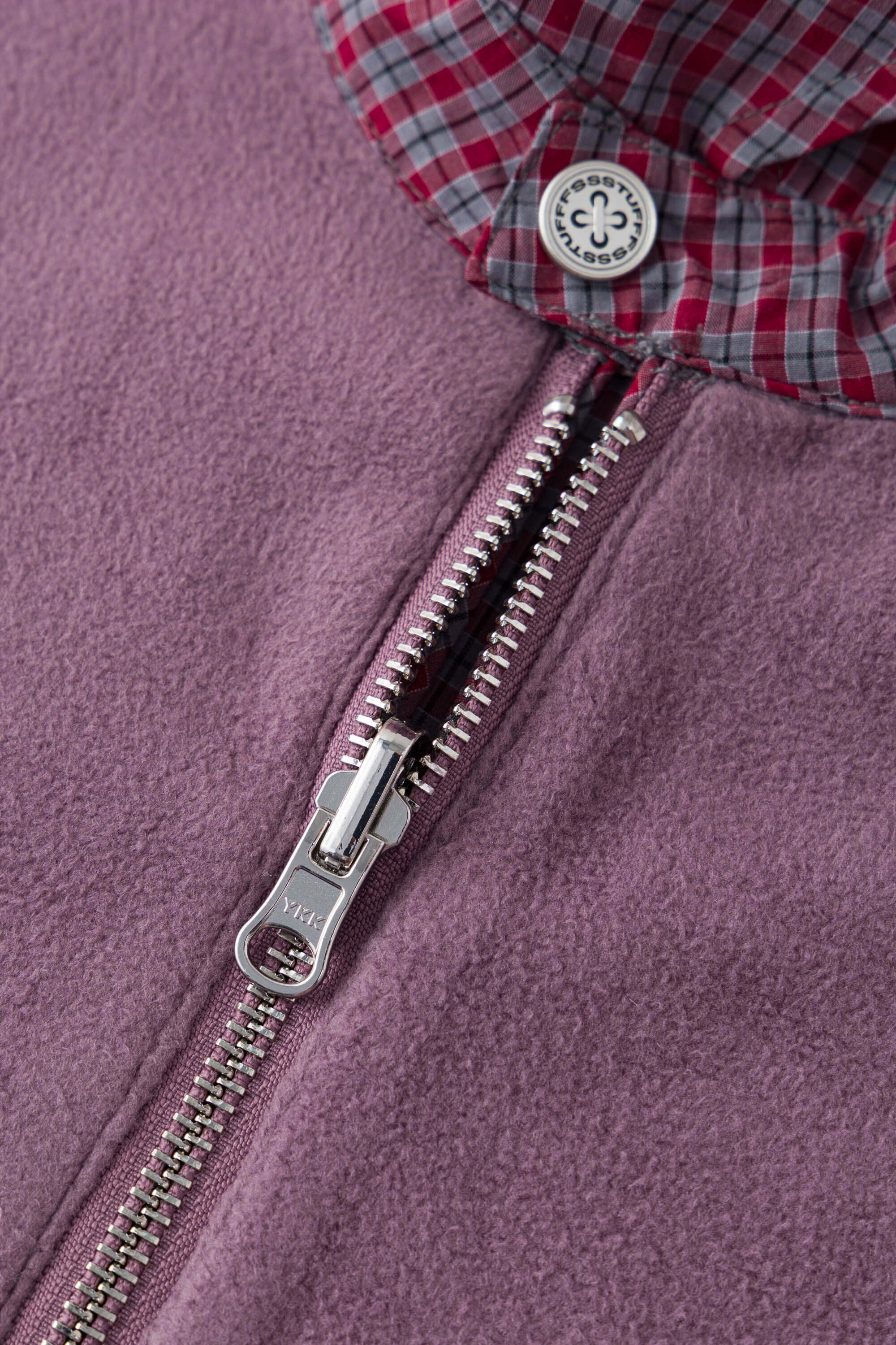 Reversible jacket with burgundy and grey micro-check pattern on one side and purple fleece on reverse