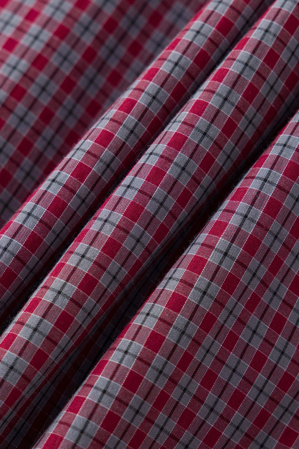 Reversible jacket with burgundy and grey micro-check pattern on one side and purple fleece on reverse