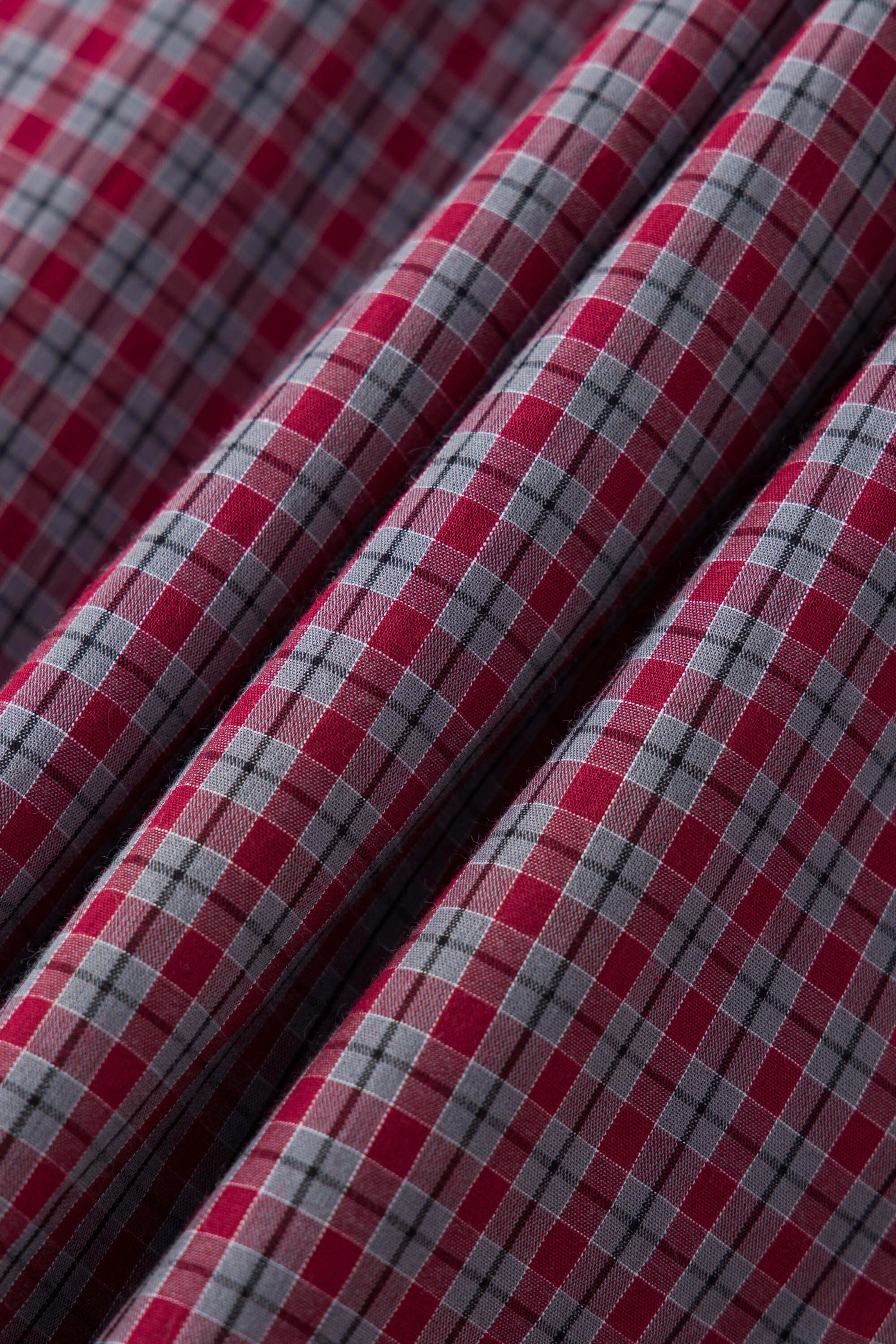 Reversible jacket with burgundy and grey micro-check pattern on one side and purple fleece on reverse