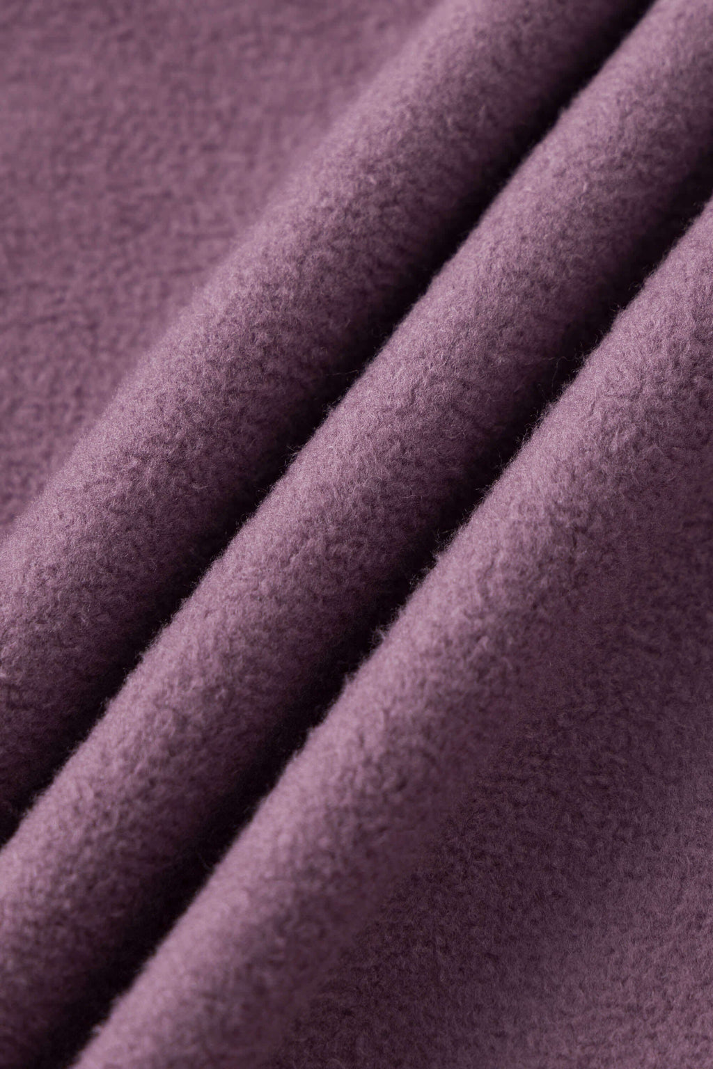 Reversible jacket with burgundy and grey micro-check pattern on one side and purple fleece on reverse