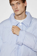 Reversible down puffer jacket with pinstriped shirt side and pastel blue side, includes two detachable ties