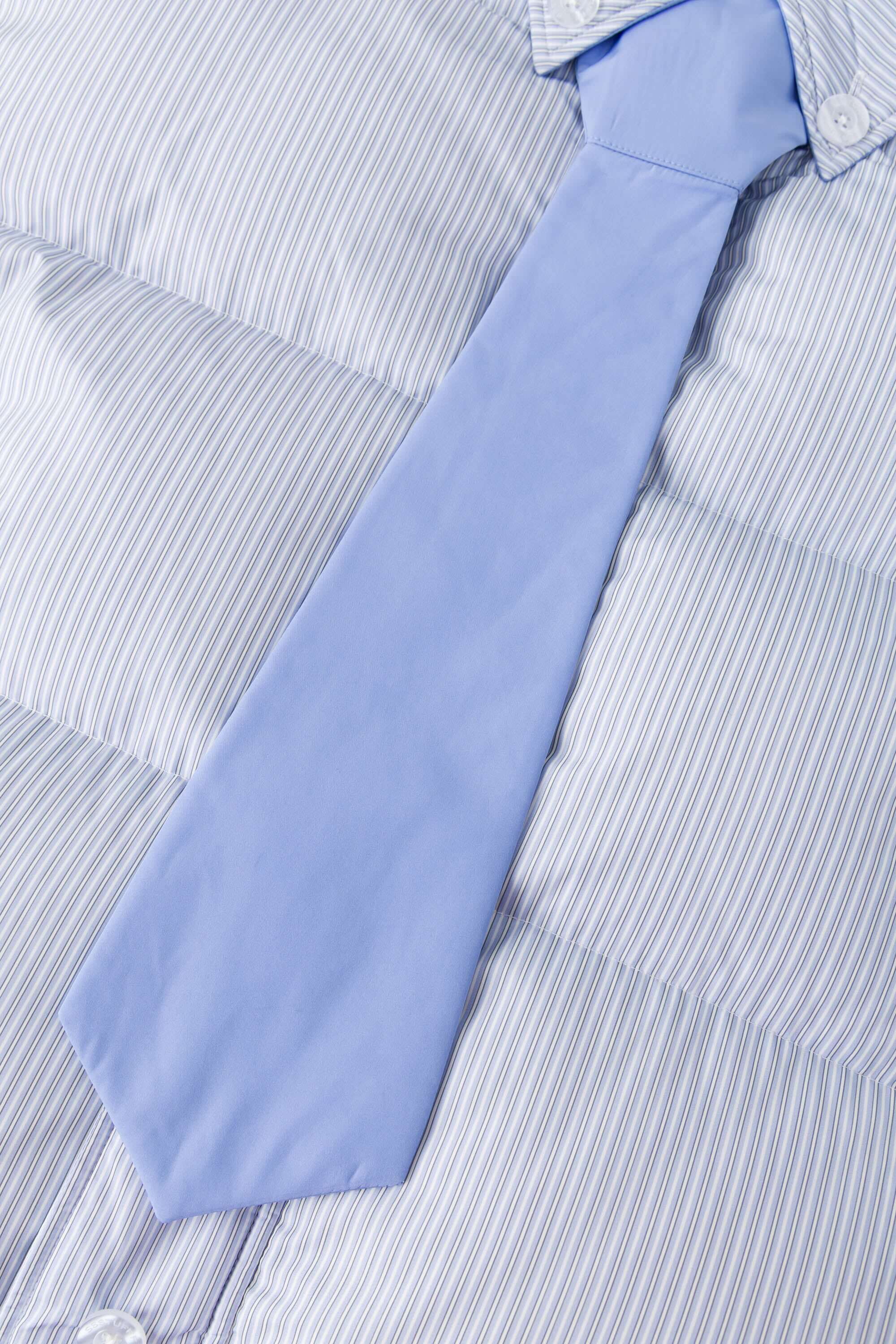Reversible down puffer jacket with pinstriped shirt side and pastel blue side, includes two detachable ties