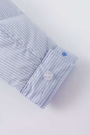 Reversible down puffer jacket with pinstriped shirt side and pastel blue side, includes two detachable ties