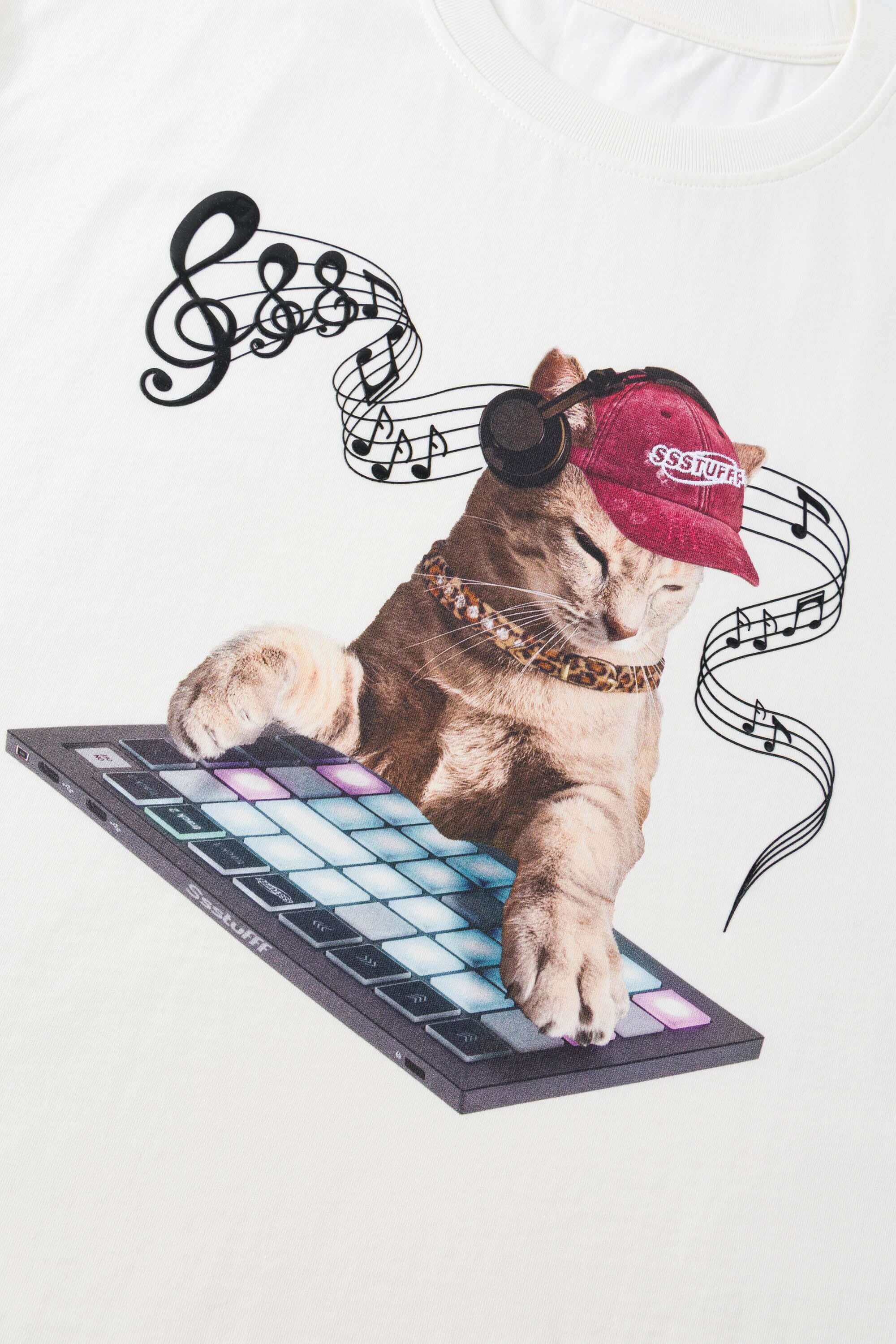 White t-shirt with embroidered SSSTUFFF logo and silicone-printed musical notes