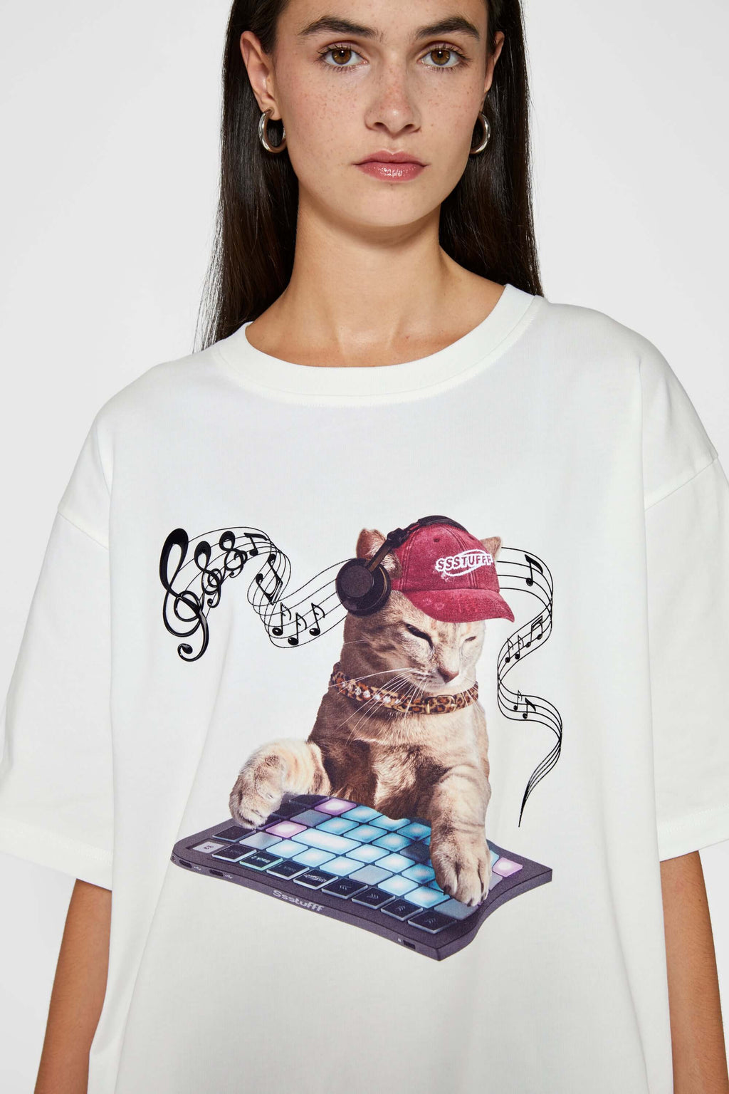 White t-shirt with embroidered SSSTUFFF logo and silicone-printed musical notes