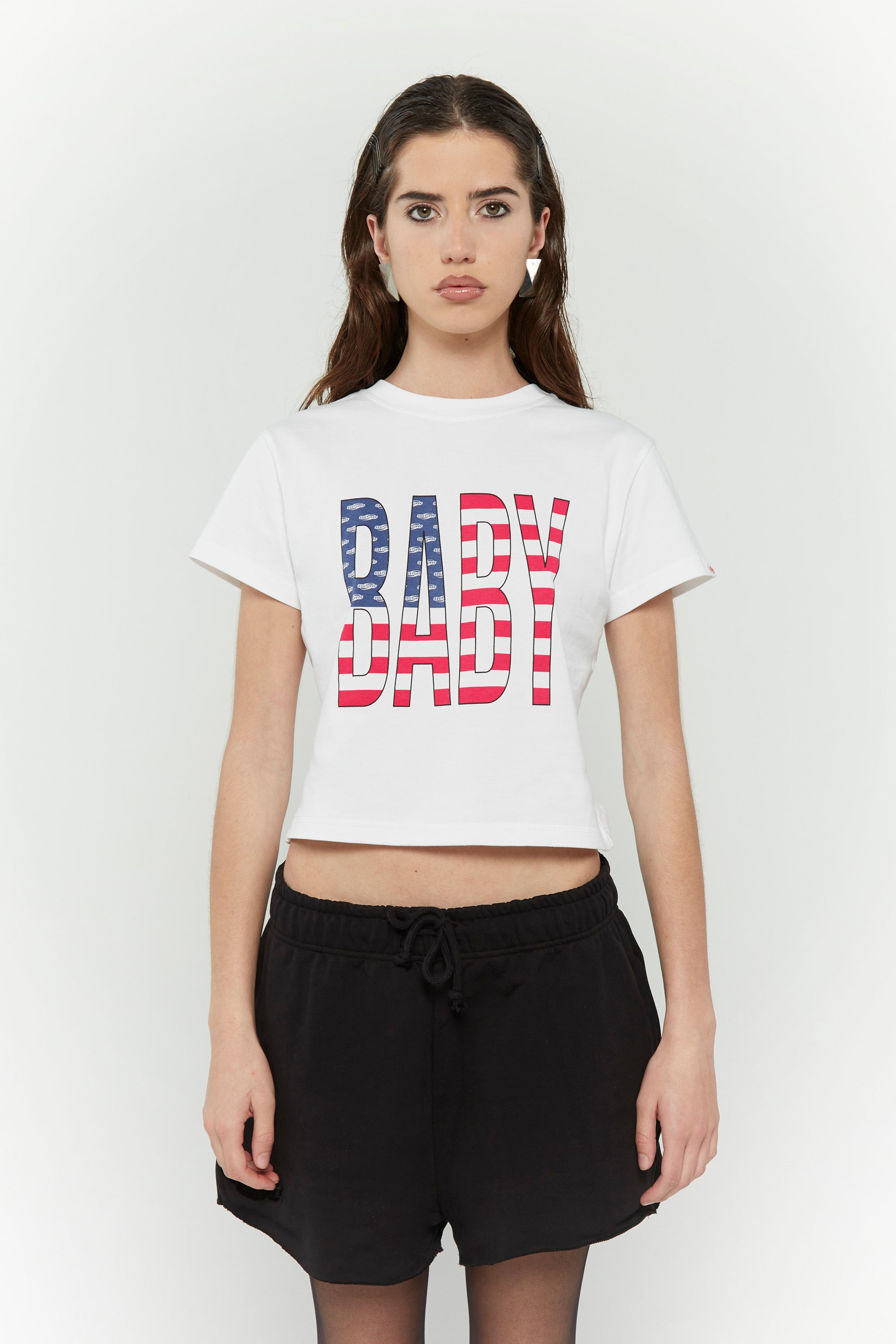White crew neck t-shirt with the text 'BABY' digitally printed in bold letters with the American flag 