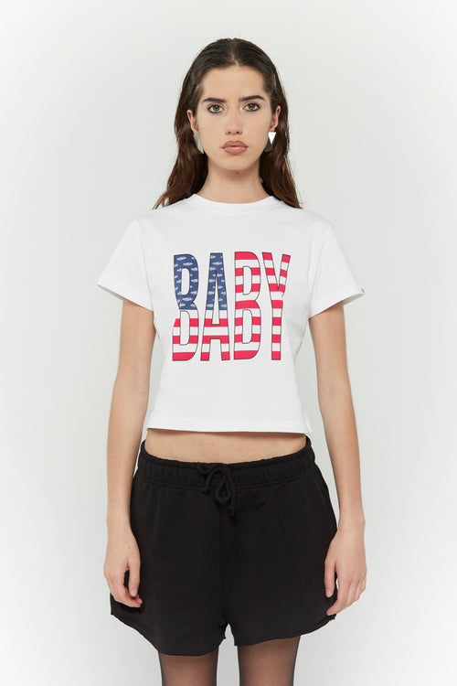White crew neck t-shirt with the text 'BABY' digitally printed in bold letters with the American flag 