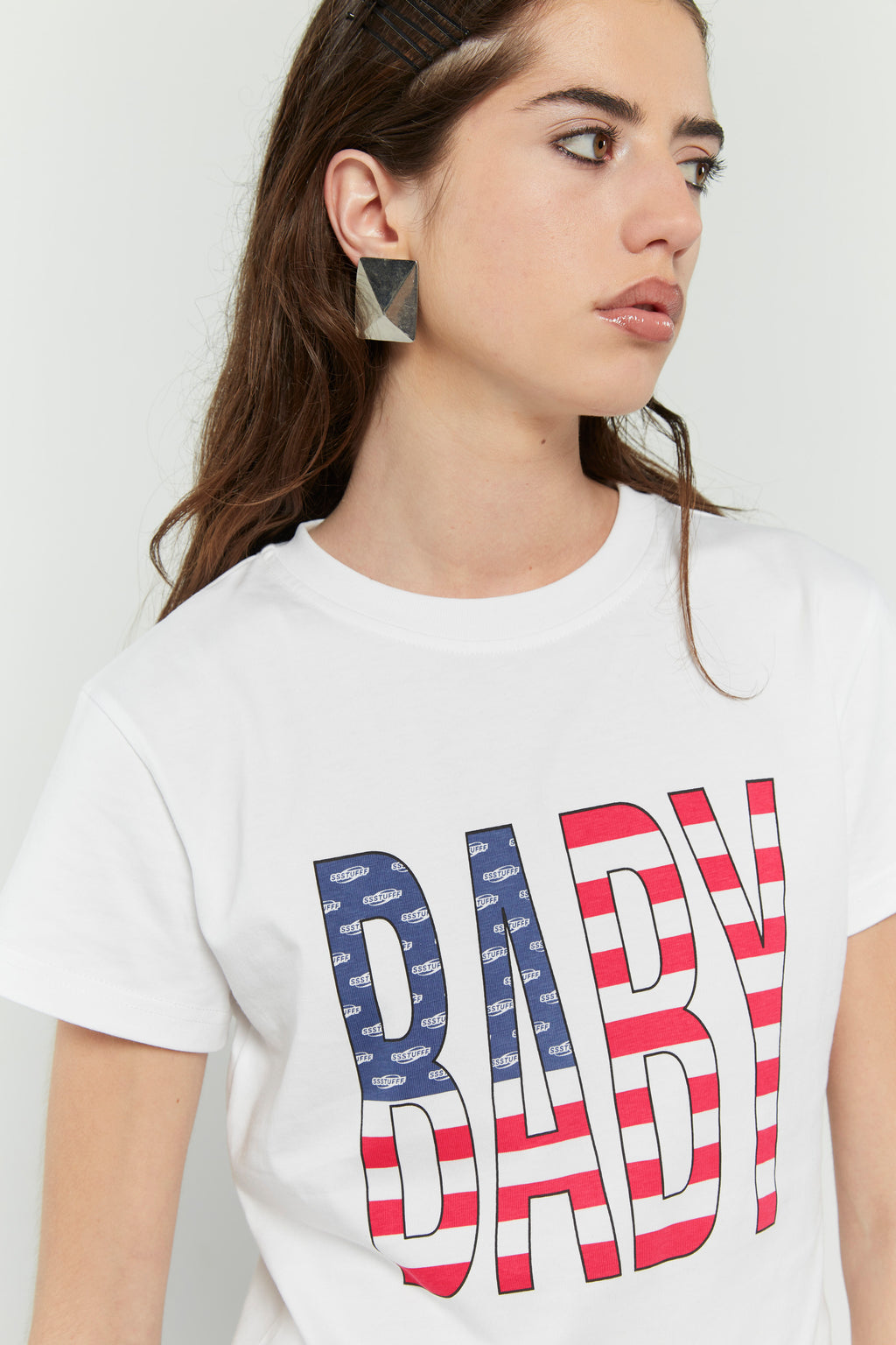 White crew neck t-shirt with the text 'BABY' digitally printed in bold letters with the American flag 