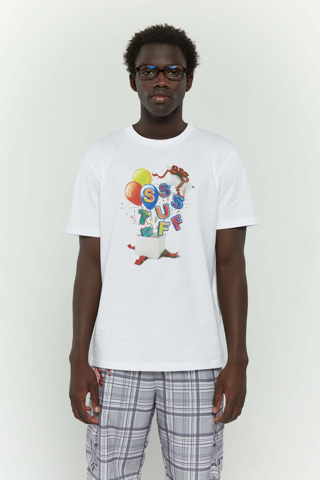 White t-shirt with colorful birthday balloons and gift graphic in CMYK screenprint"