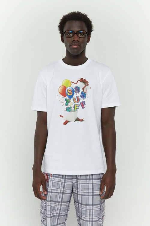 White t-shirt with colorful birthday balloons and gift graphic in CMYK screenprint"