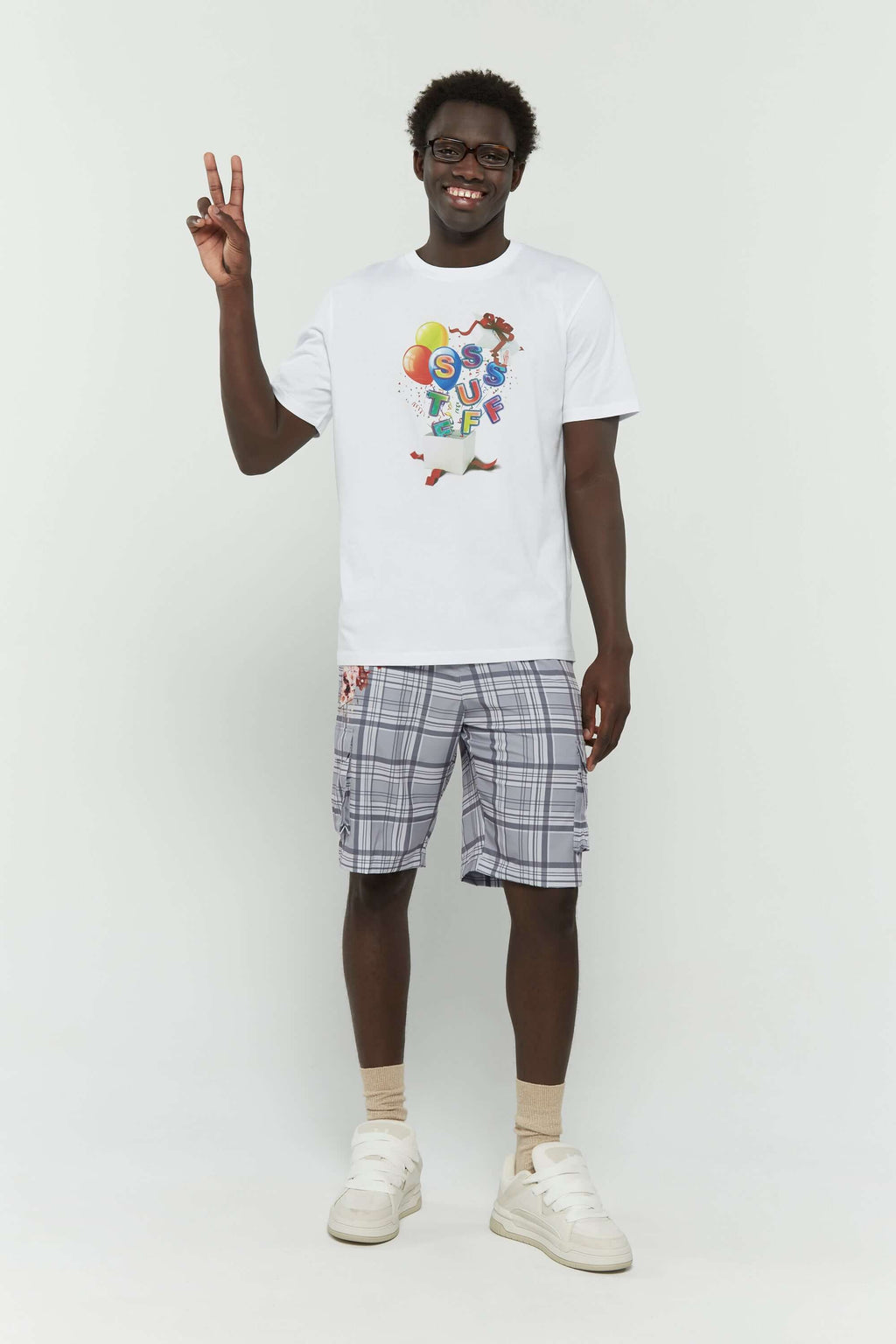 White t-shirt with colorful birthday balloons and gift graphic in CMYK screenprint"